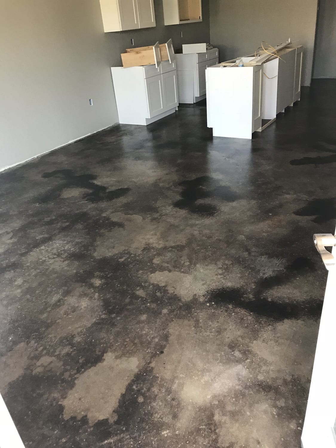 Mottled black acid stained concrete floor