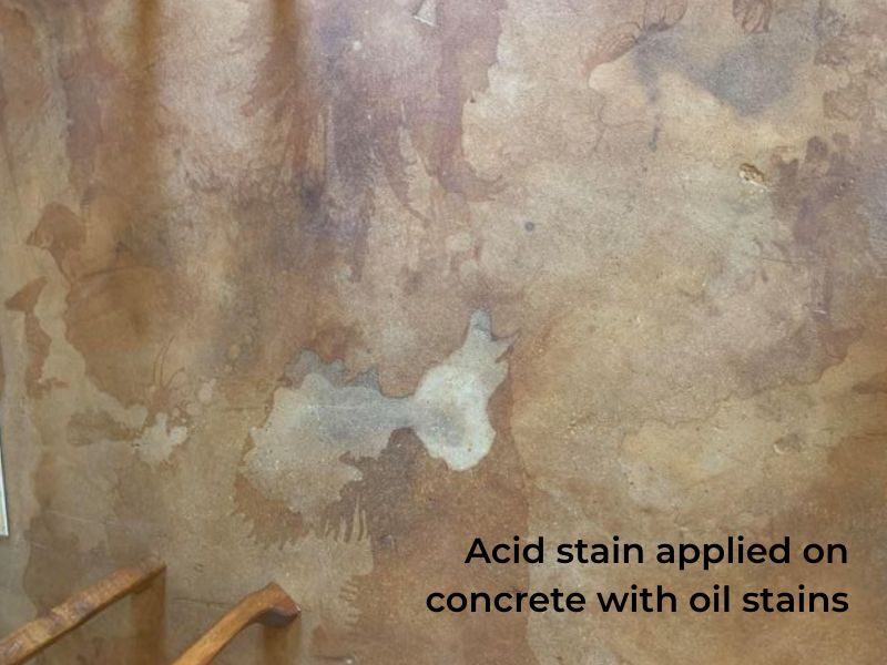 Acid-stained floor with unstained spots from oil spills.