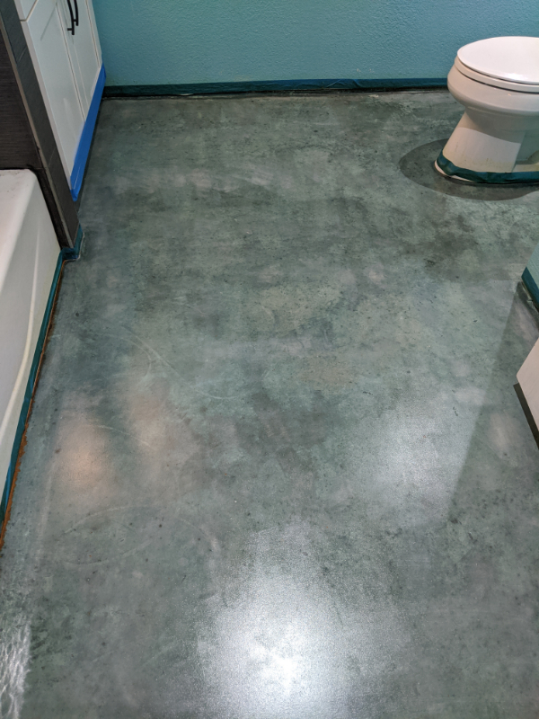 Azure blue acid-stained concrete bathroom floor