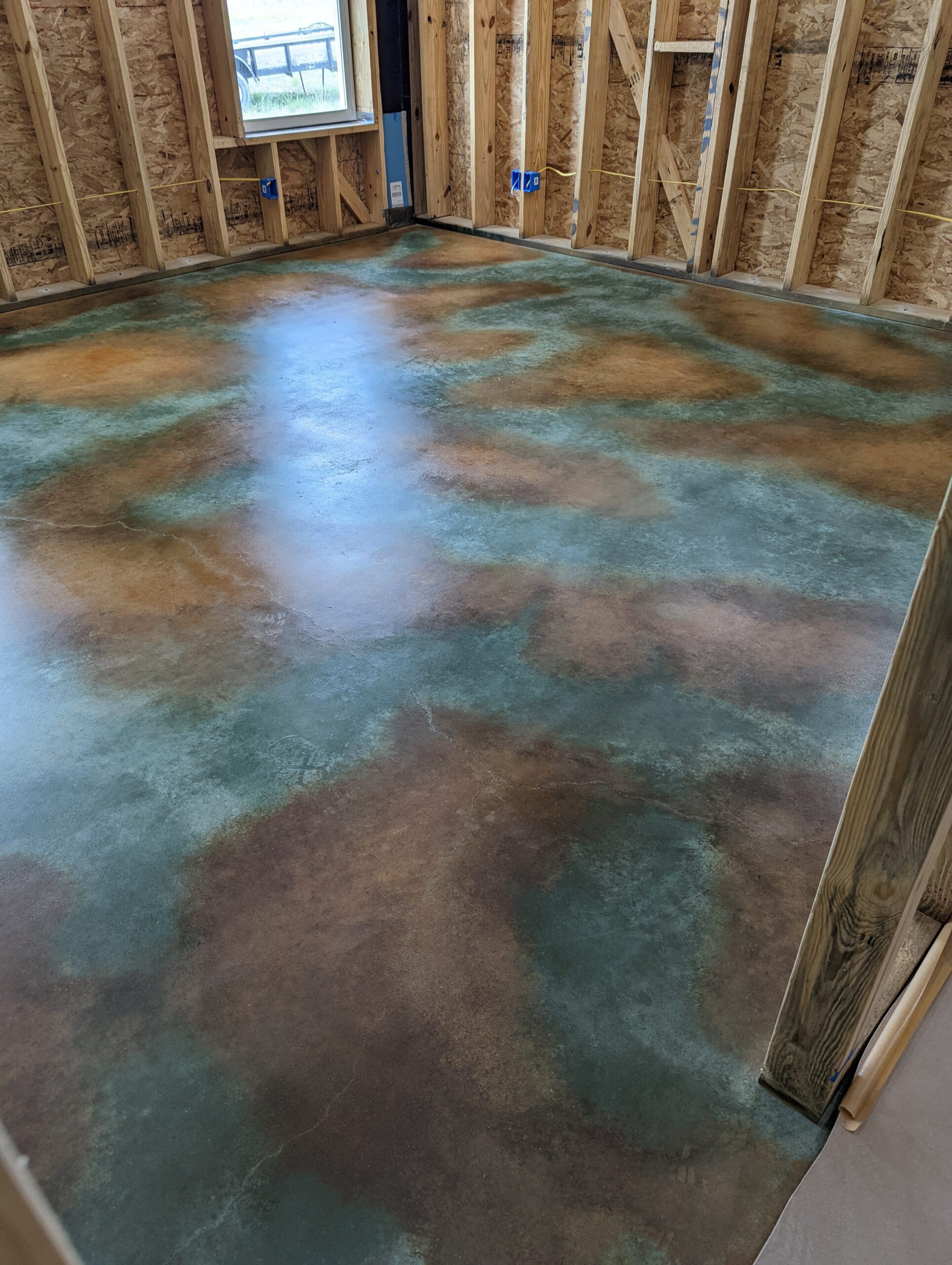 barndominium floor transformed into a stunning, multi-layered and protected surface with acid staining and sealing