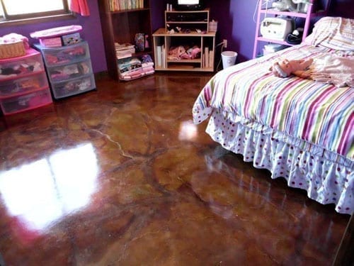 Girl's bedroom and homeschool classroom with concrete stained flooring.