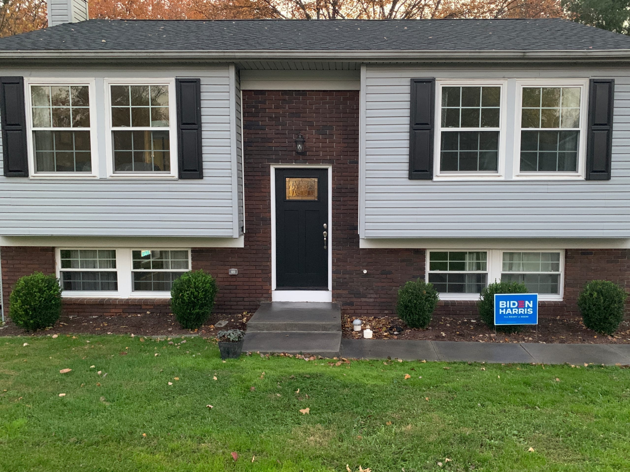 After photo of a bilevel home with brick facade stained in charcoal