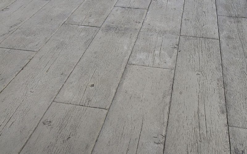 Stamped concrete overlay designed to look like wood planks