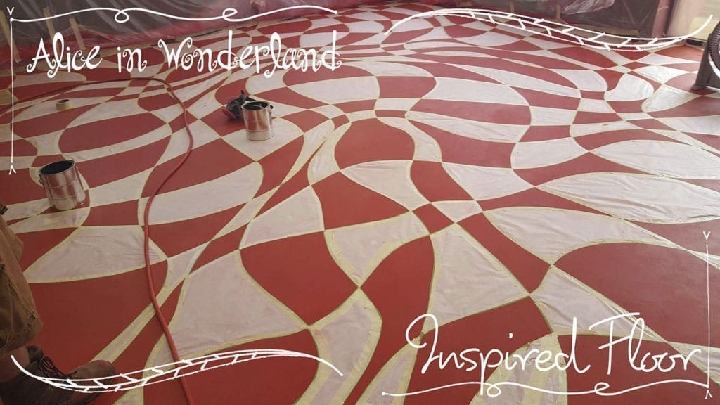 A concrete floor colored with concrete dye inspired by Lewis Carrol's Alice in Wonderland.
