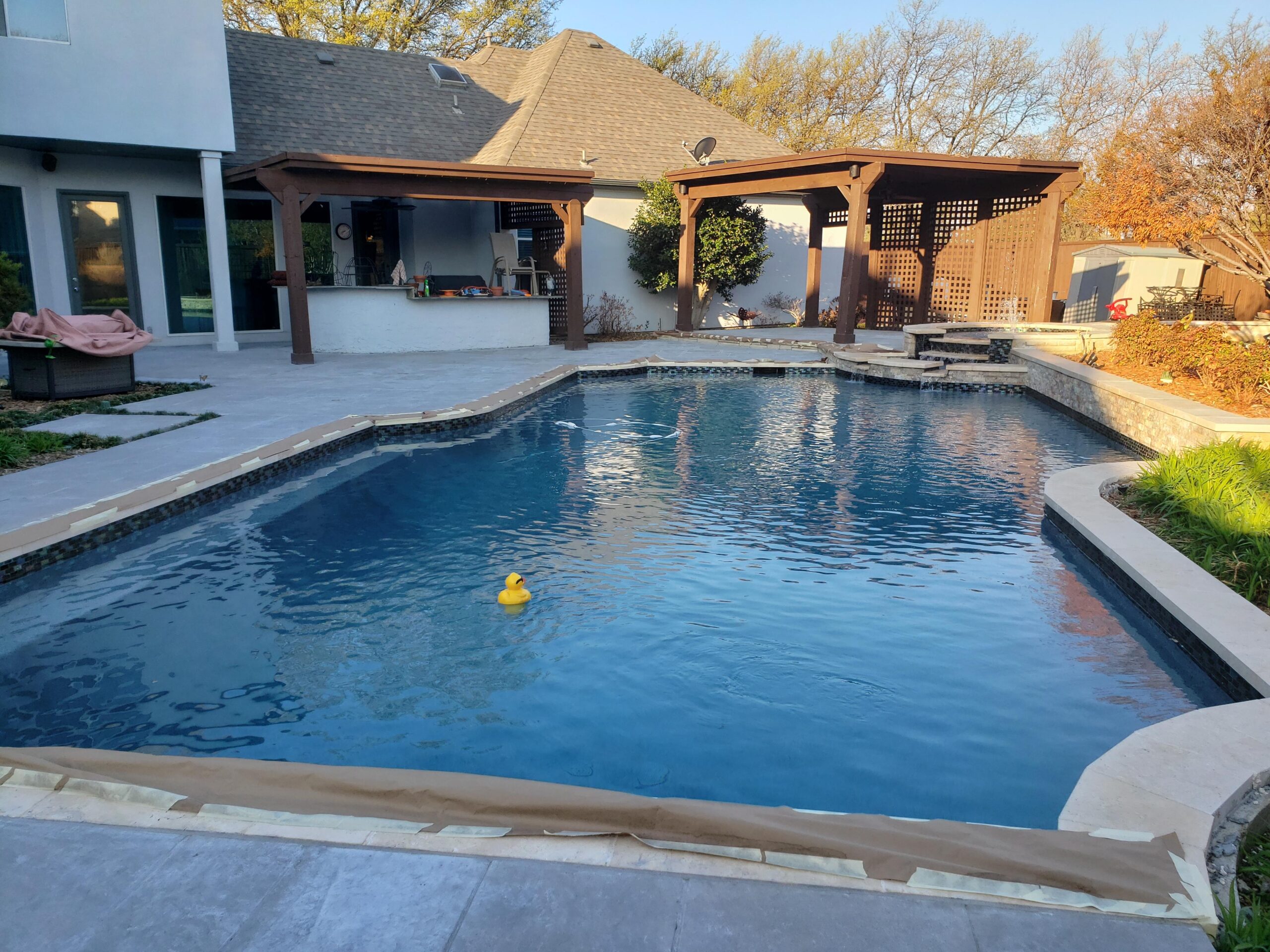 transformed stamped concrete pool deck, now sporting a stylish stain and sealed finish