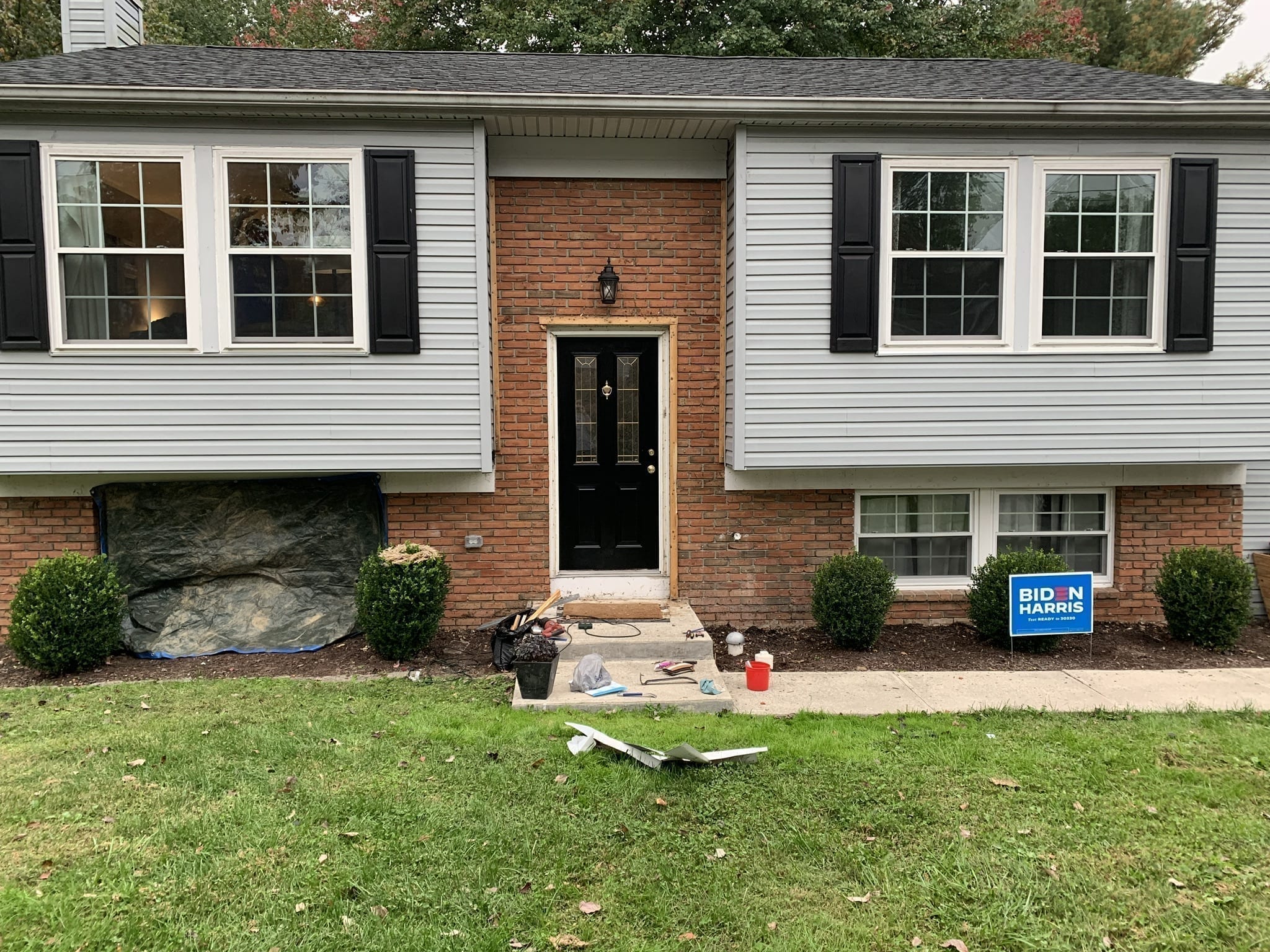 Before photo of a bilevel home with brick facade