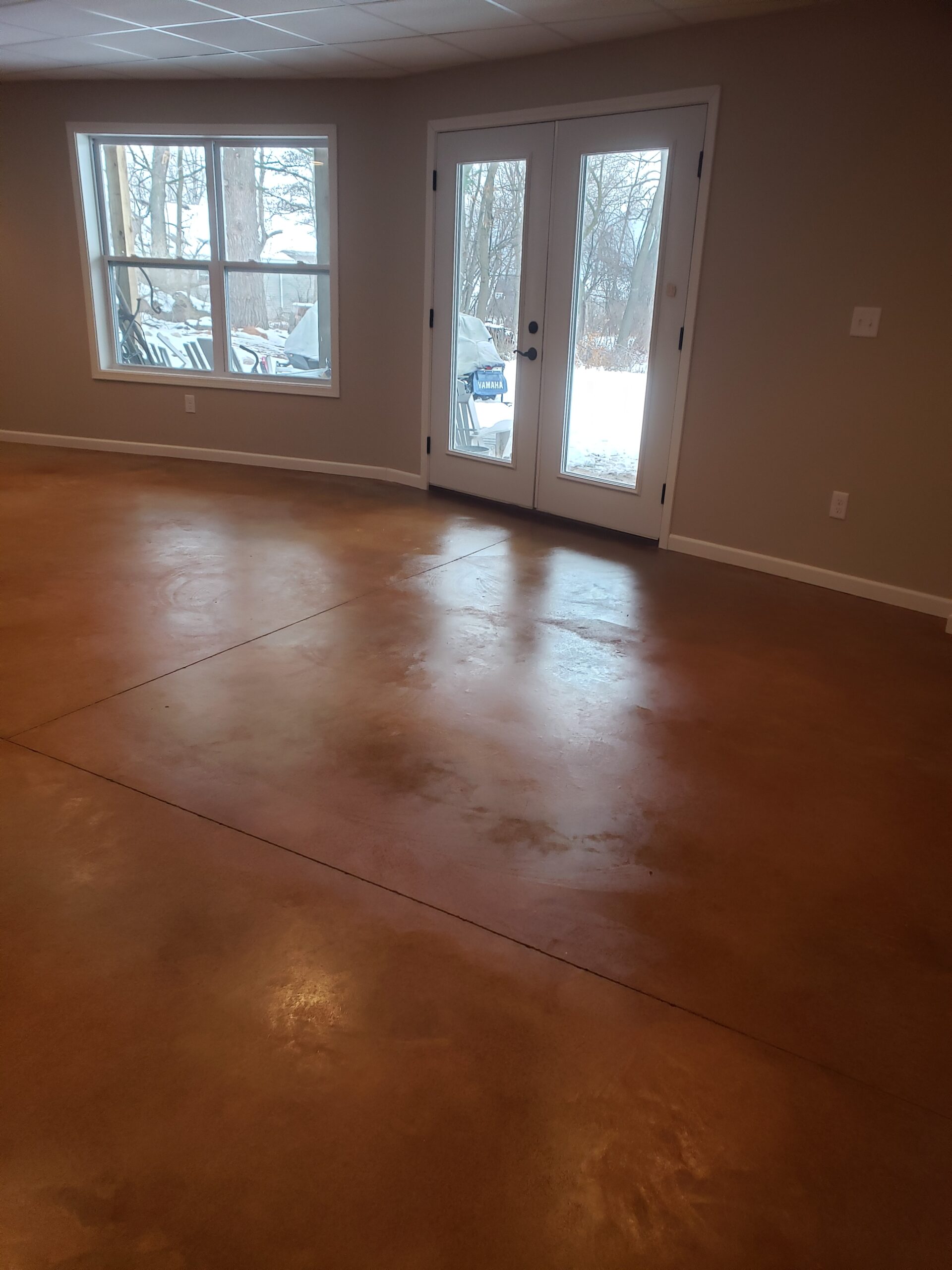 Malayan Buff EverStain and AcquaSeal stained living room concrete floor