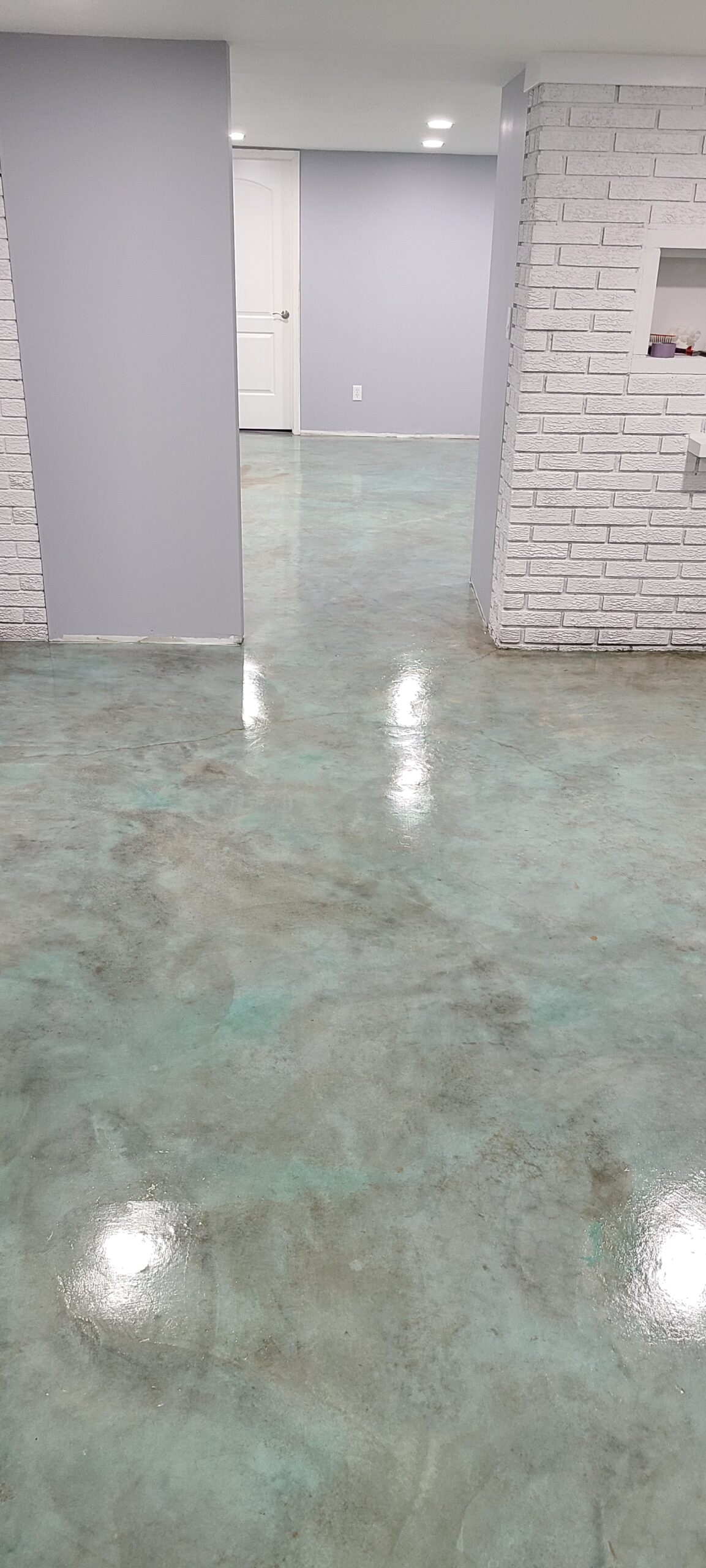 Stained concrete basement floor with Azure Blue EverStain acid stain