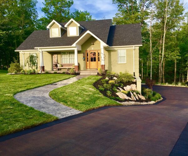 Long side driveway stained with coffee brown acid stain and edged with charcoal EasyTint for added detail.