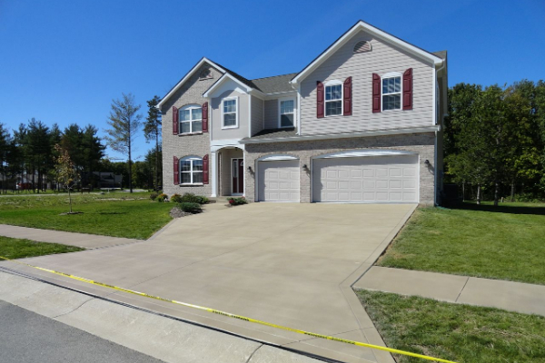 Buff stained broomed finish concrete driveway