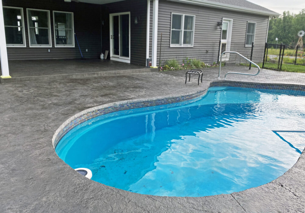 Rejuvenated stamped concrete pool area after application of Black Antiquing stain and EasySeal high gloss sealer.