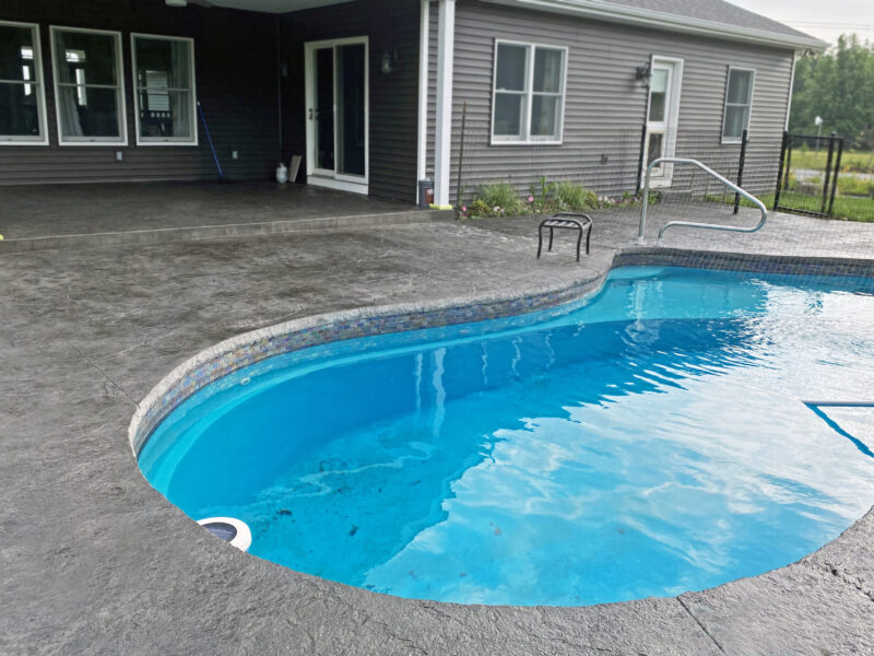 Rejuvenated stamped concrete pool area after application of Black Antiquing stain and EasySeal high gloss sealer.