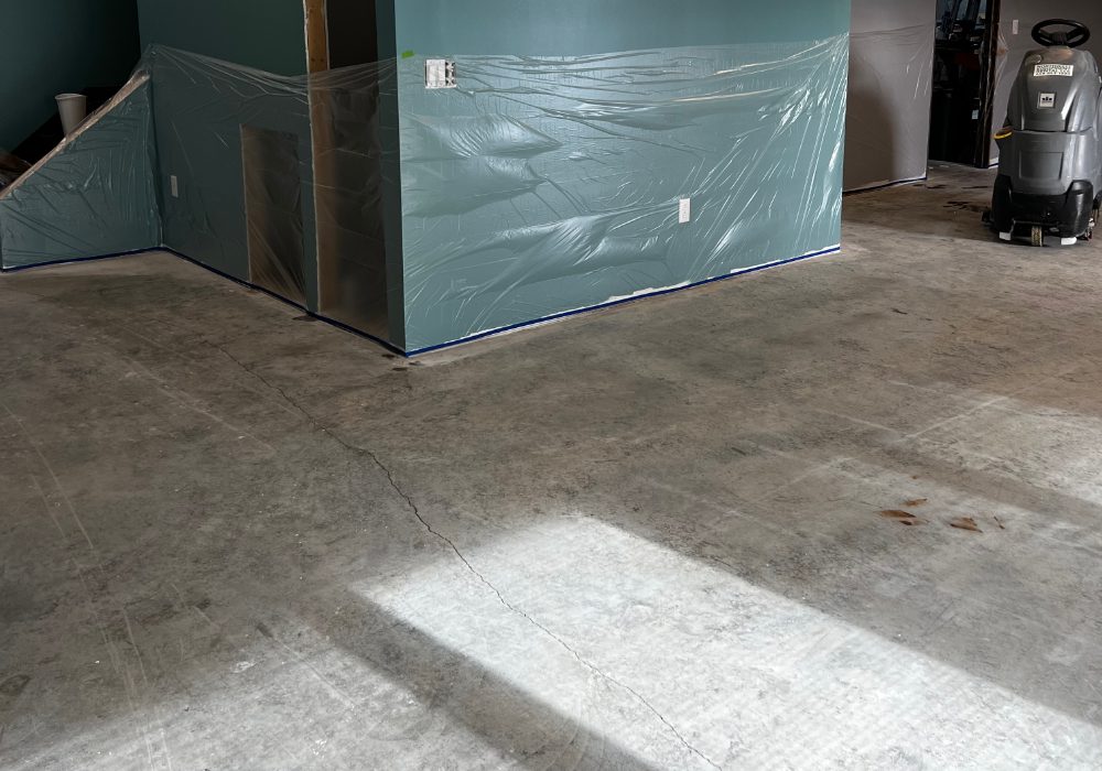 A bare, untreated basement floor prior to the application of Everstain acid stain