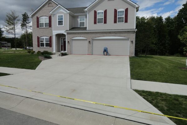 Before photo of a plain concrete driveway