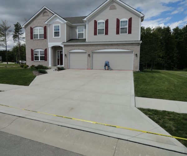 Before photo of a plain concrete driveway