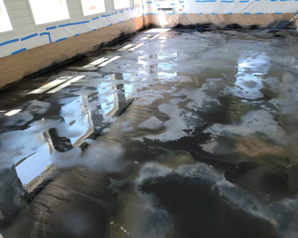 ColorWave Stains in Black, Stone Gray, and Iron Gray Applied Using Puddling Method on Concrete Floor