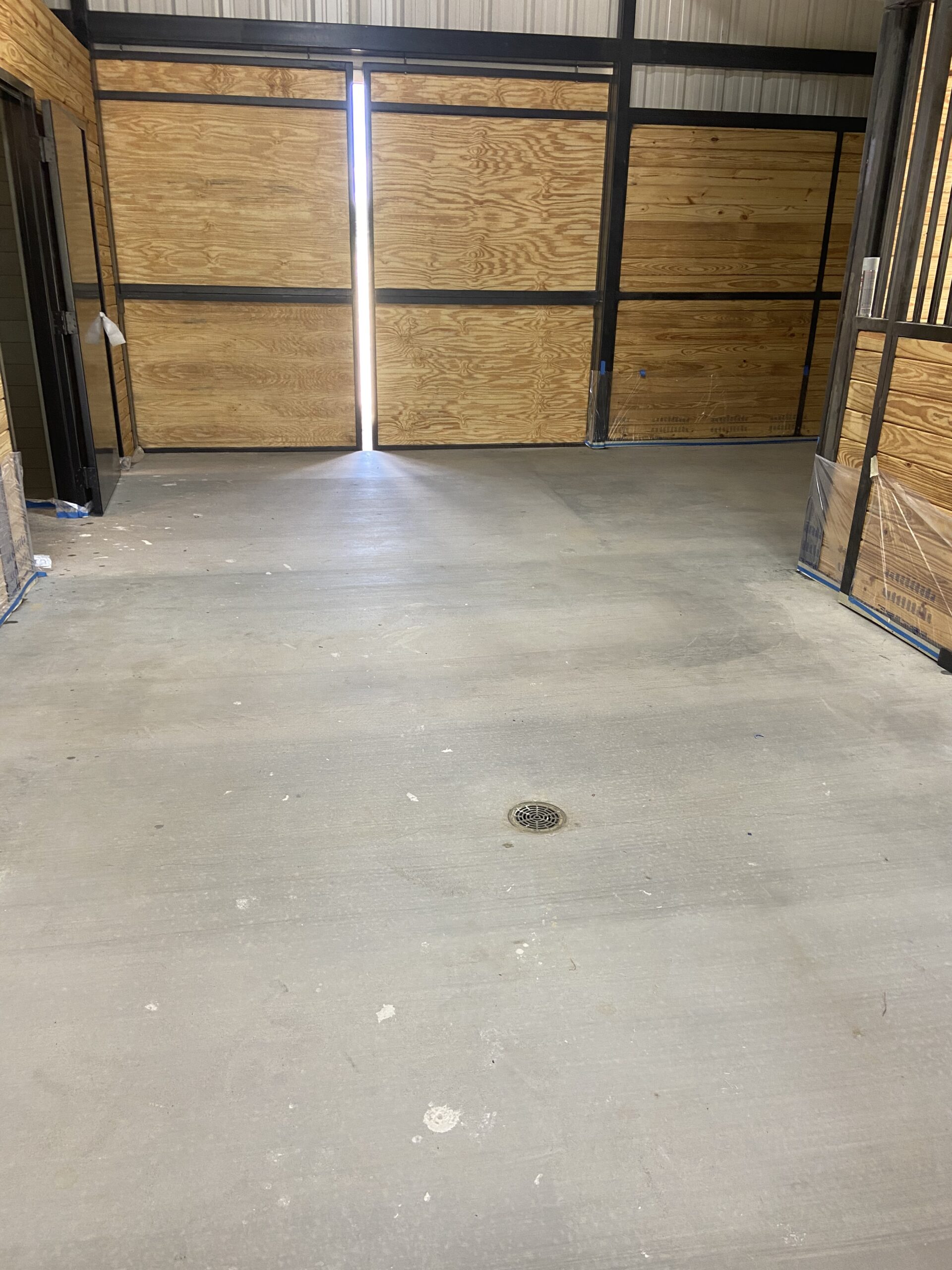 Pre-stain photo displaying the original condition of the barn's concrete floor