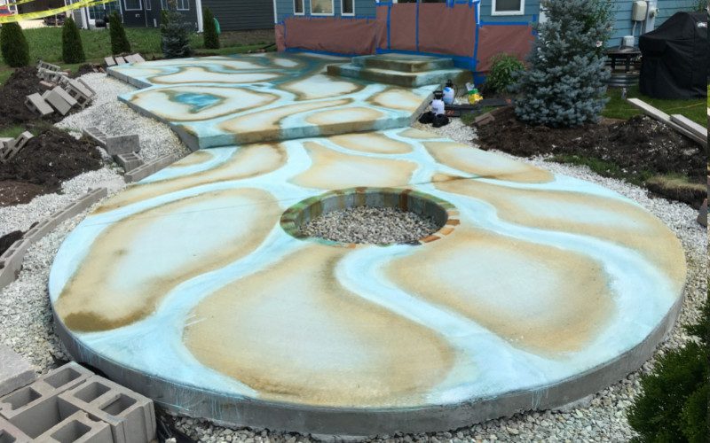 A chalky residue is a normal part of the acid staining process as the stain reacts with the minerals in the concrete and dries.