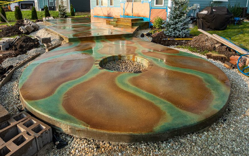 Neutralizing and rinsing the acid stain residue from the concrete surface to prepare it for sealing.