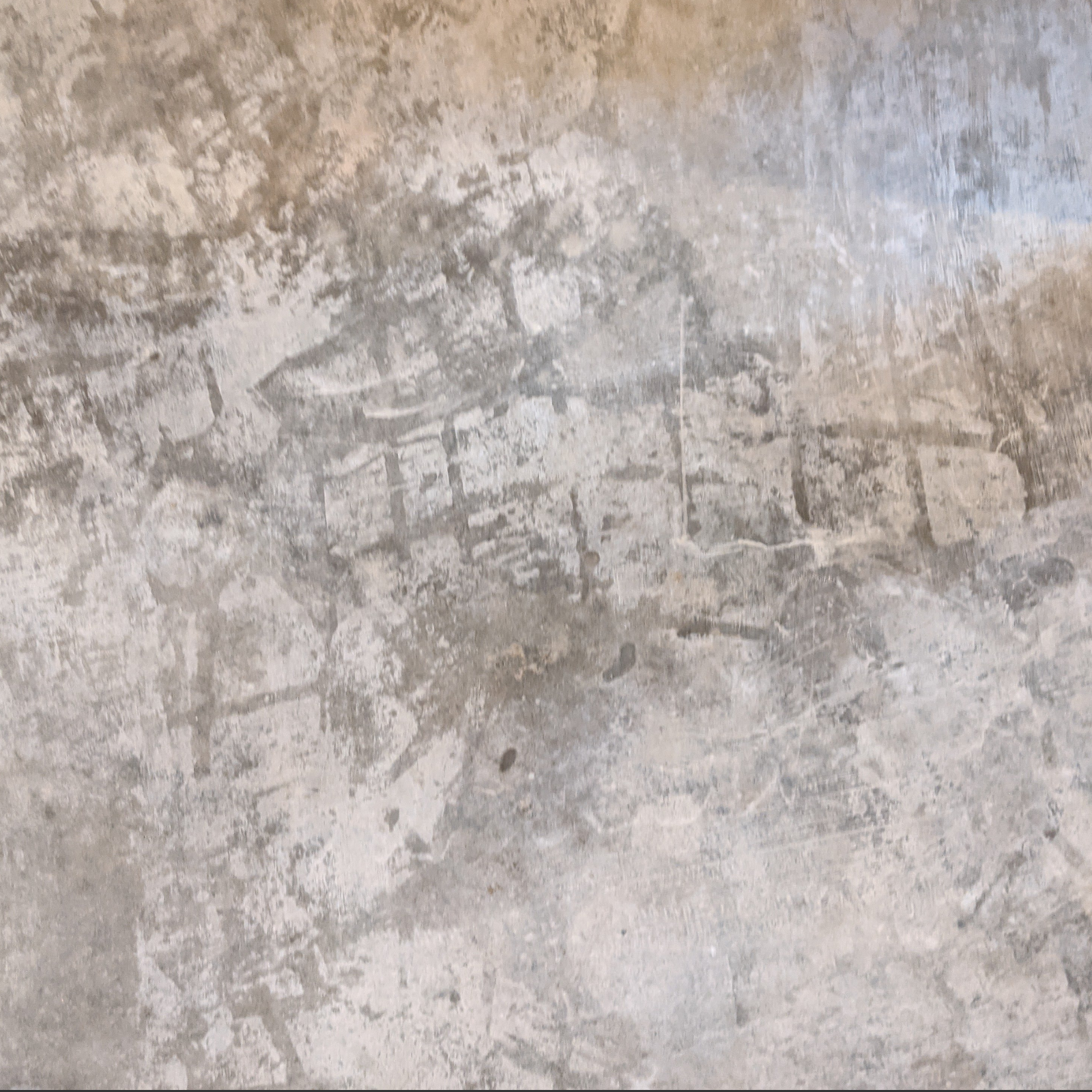 Close-up of etched footprints on dry concrete floor before staining
