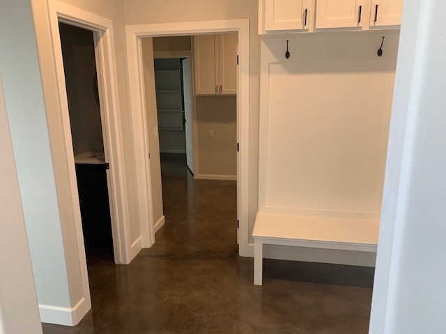 Foyer featuring a concrete floor dyed with an elegant combination of Stormy Gray, Driftwood, and Charcoal Vibrance Dye
