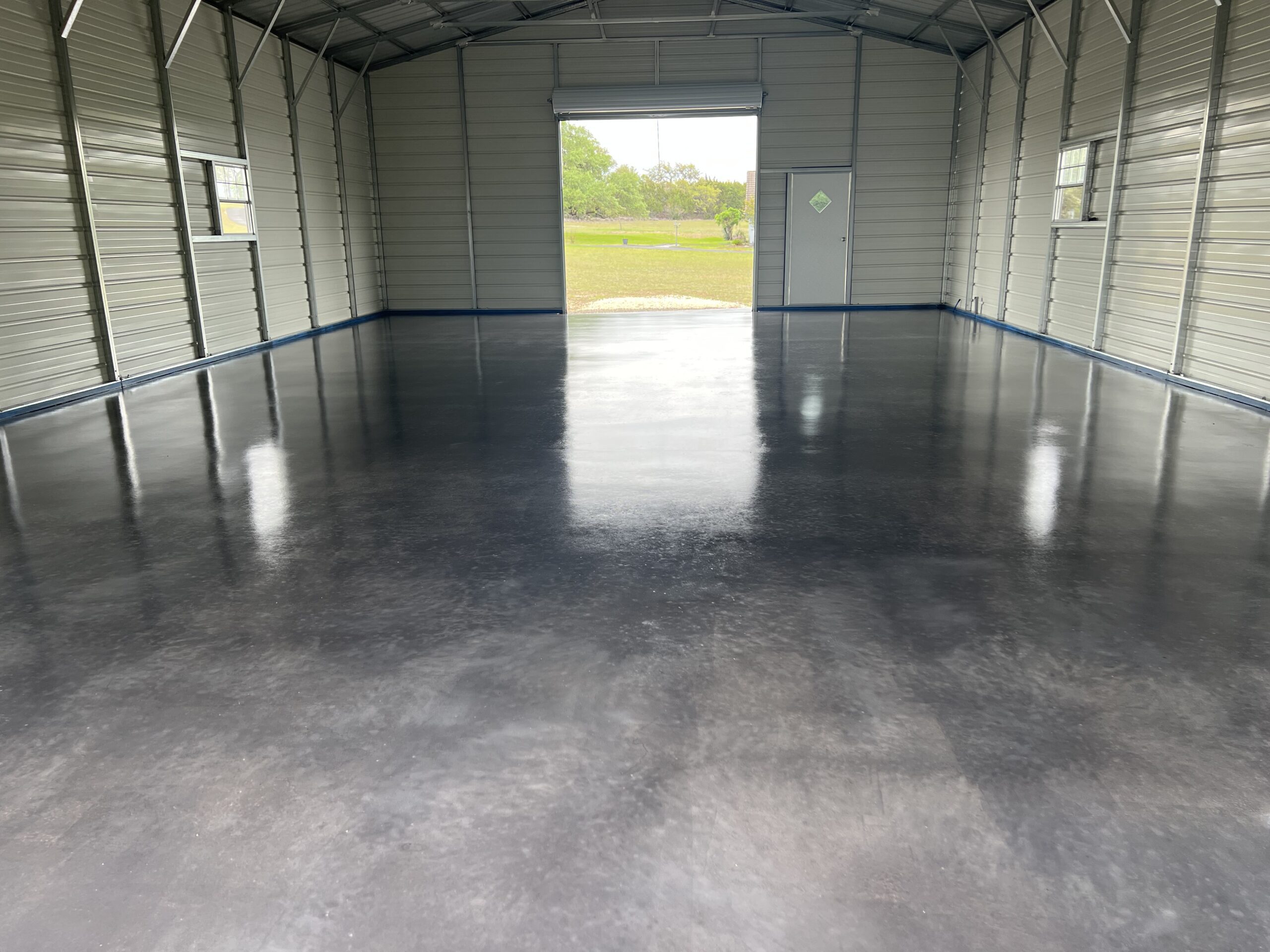 Finished modern and sleek barndominium floor showcasing the glossy effect of Charcoal AcquaTint™ with satin ProWax Polish