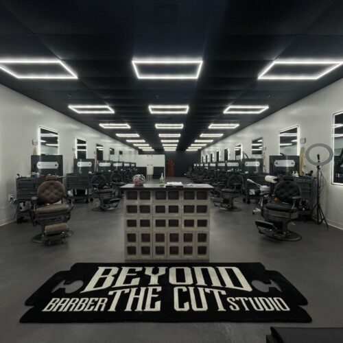 Image showcasing the finished concrete floor in the newly opened barbershop, featuring modern, industrial aesthetics with varying tones of gray and black, exuding a masculine ambiance.