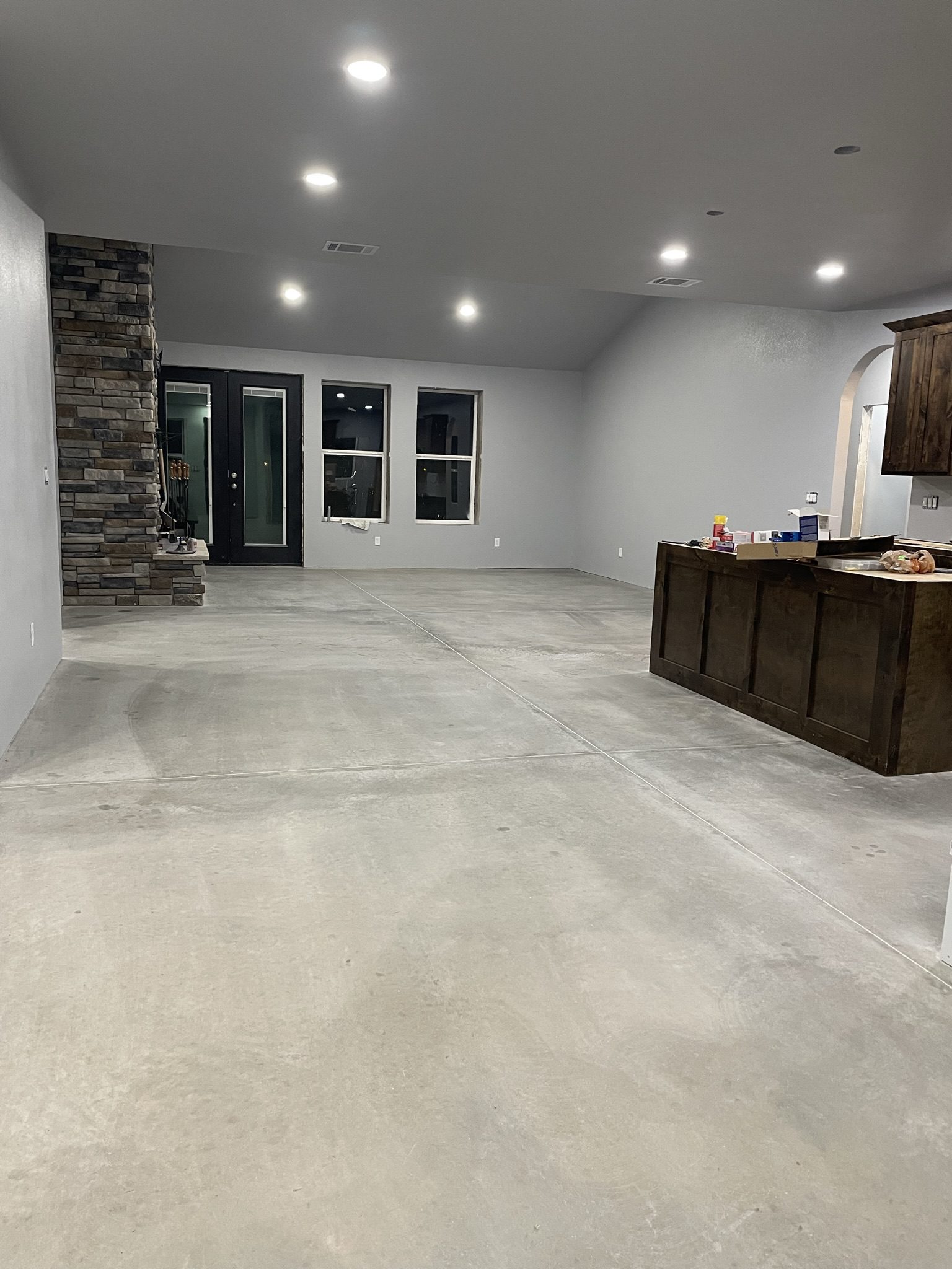 A photo showing the concrete floor where citrus etching was ineffective, and the buffing machine used as an alternative to properly prepare the surface for sealing.