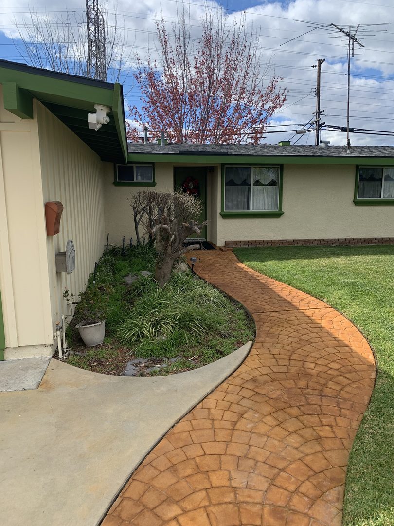 A snaking concrete walkway with a rich cola stain