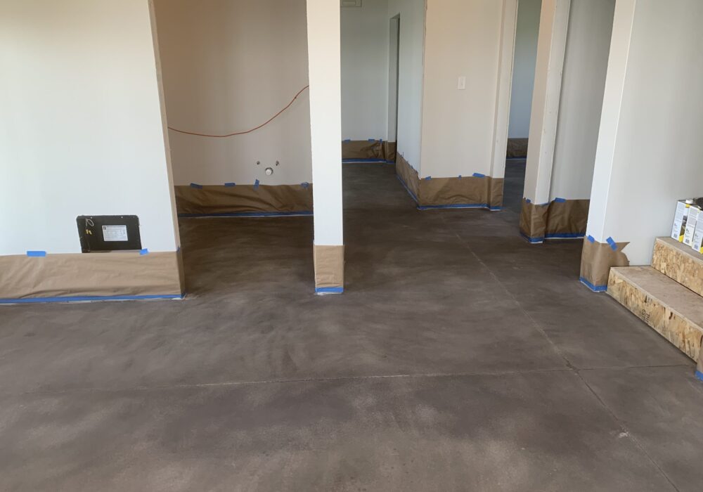 Cabin concrete floor showing the initial coat of Stormy Gray Vibrance Dye