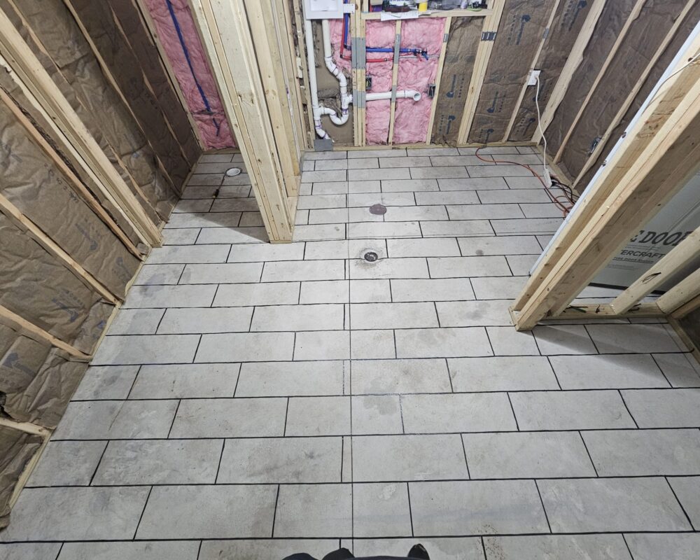 Concrete floor with duct tape neatly arranged following the chalked tile pattern