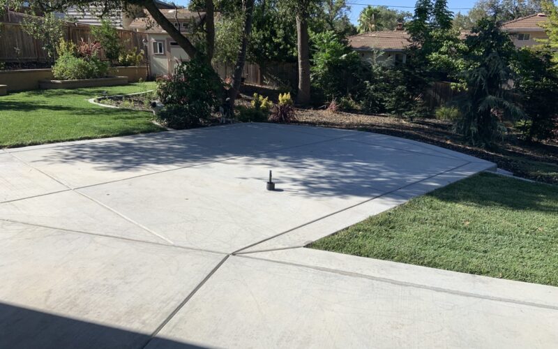 Unstained, broomed concrete of an outdoor kitchen ready for application of Cola stain