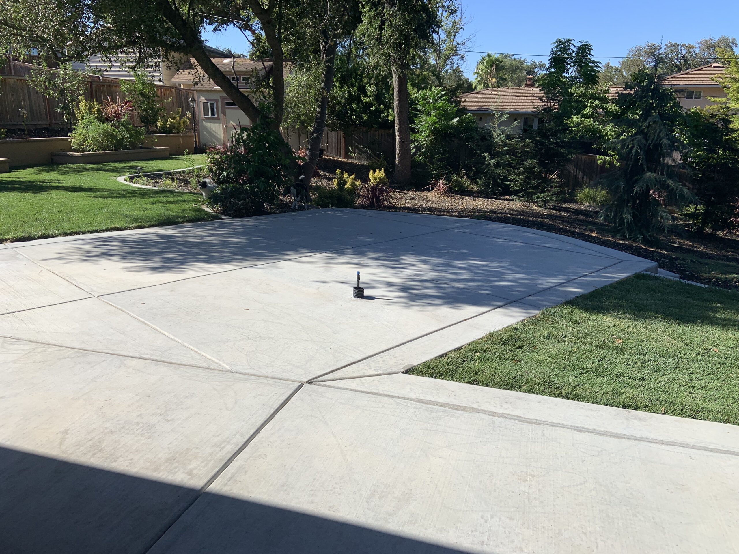 Unstained, broomed concrete of an outdoor kitchen ready for application of Cola stain