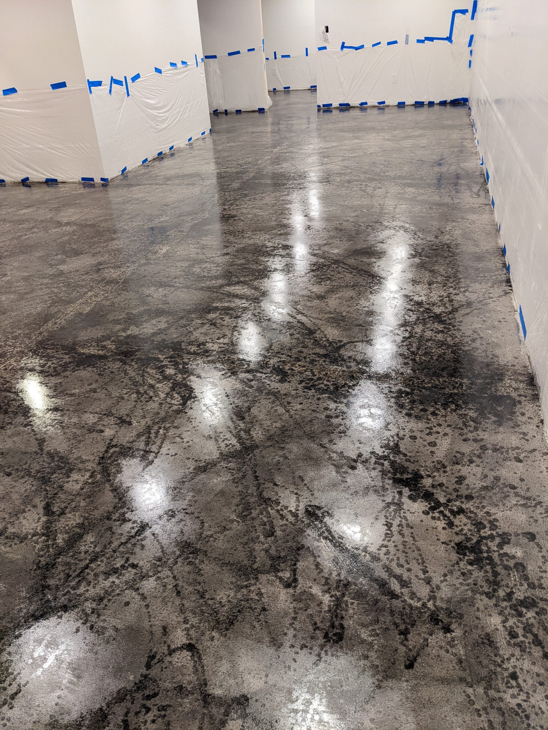 Stained concrete basement floor with colored concrete sealers