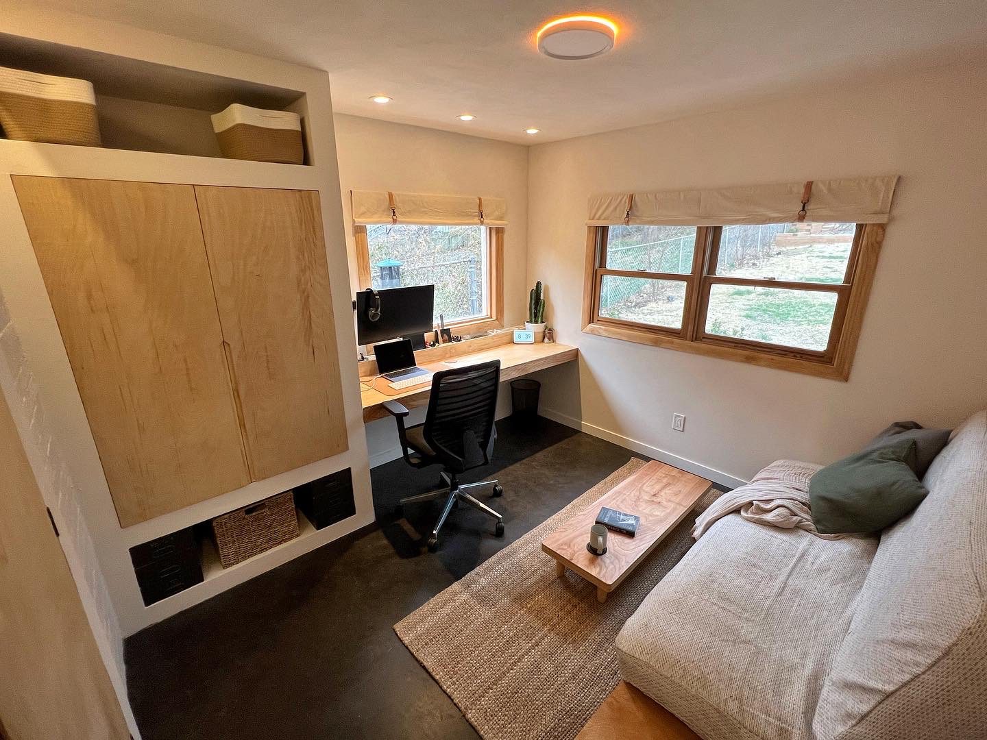 Fully furnished guest bedroom showcasing a beautifully dyed concrete floor.