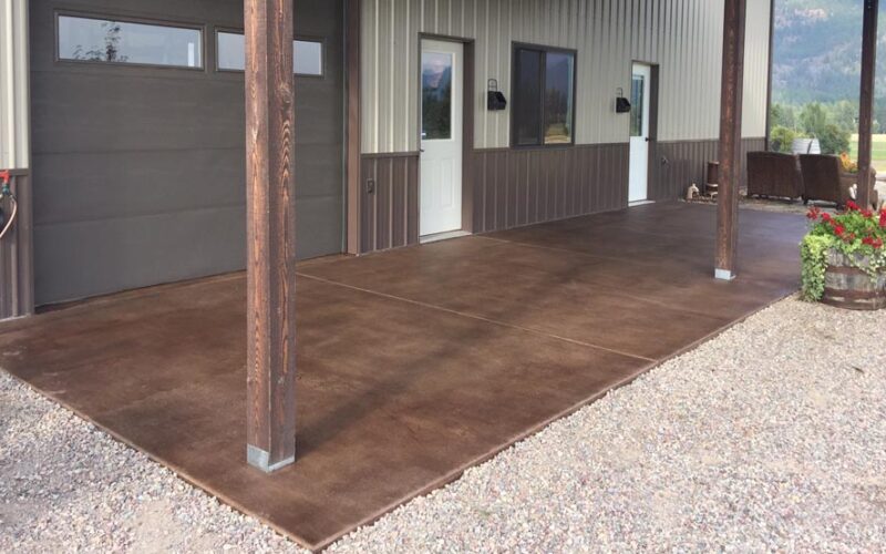 The same outdoor area post application of driftwood concrete stain, showcasing a broomed finish