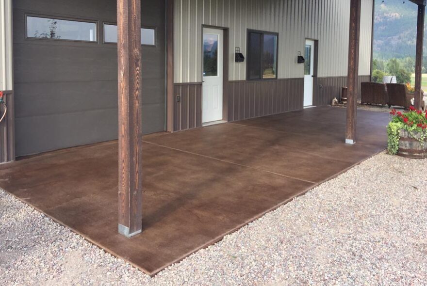 The same outdoor area post application of driftwood concrete stain, showcasing a broomed finish