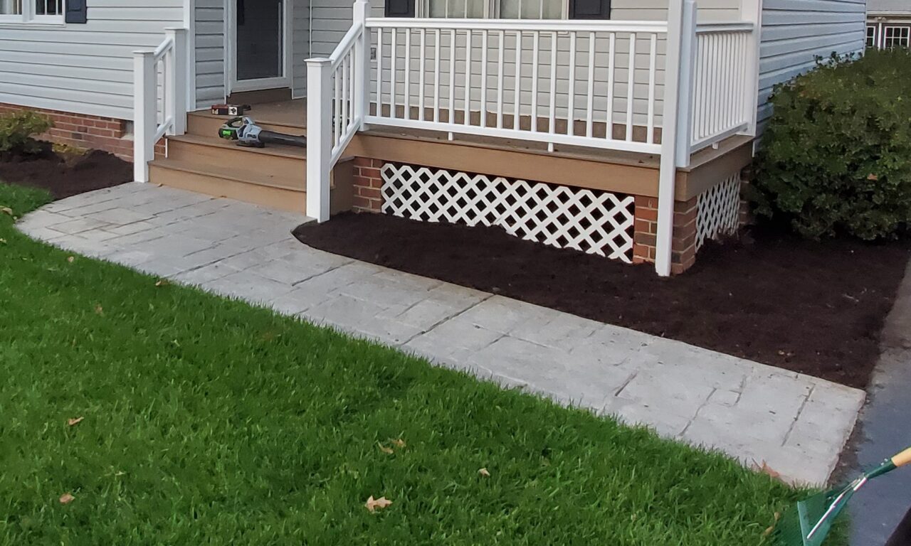 Faded stamped concrete walkway before restoration