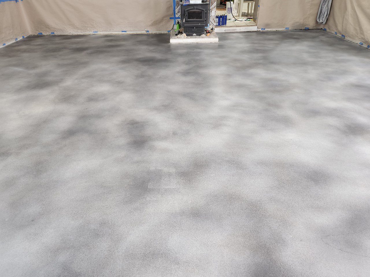 After Applying Vibrance Dye - Concrete floor freshly coated in hues of White, Stormy Grey, and Charcoal, showing a beautiful marbled effect