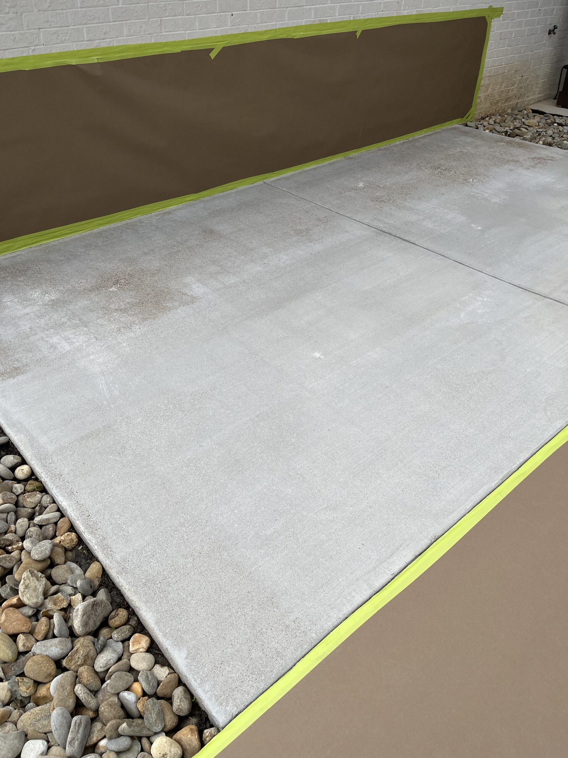 Unfinished broomed concrete front patio prior to staining