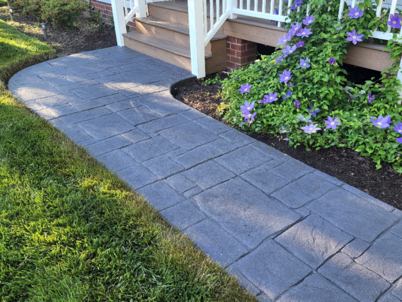 Freshly renovated sidewalk with charcoal antiquing stain and satin finish
