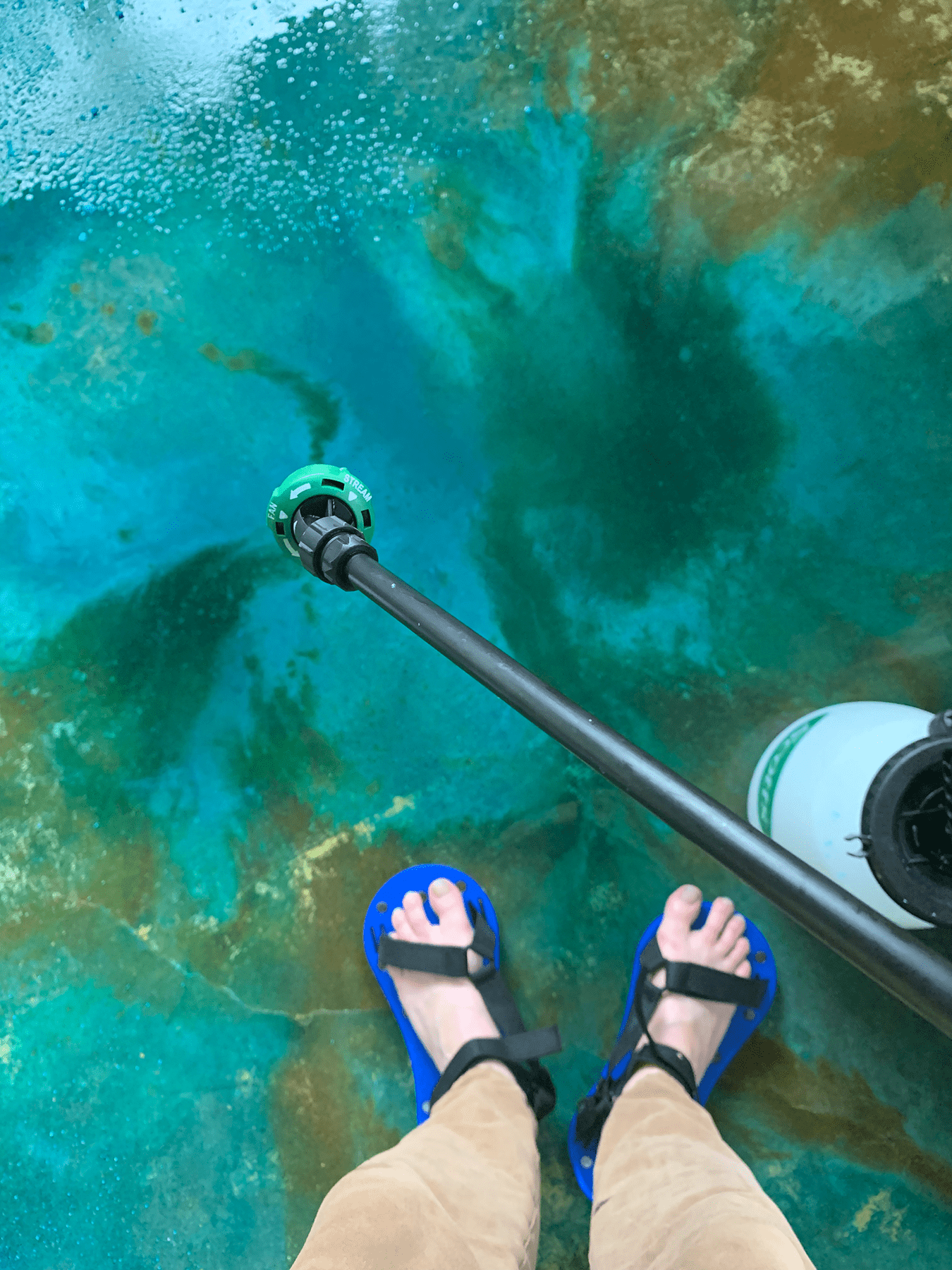 Application of Azure Blue acid stain, mixed with MiracleGro, on the porch floor using a pump sprayer