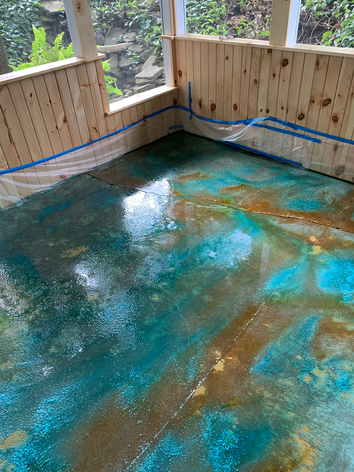 Porch floor after application of Azure, Seagrass, and English Red acid stains