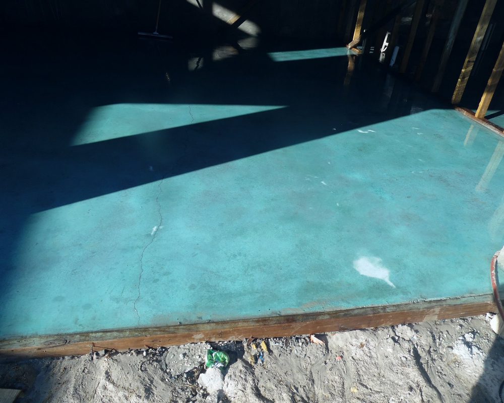 Close-up of the wet Azure Blue Acid Stain showcasing its vibrant hue on the concrete surface