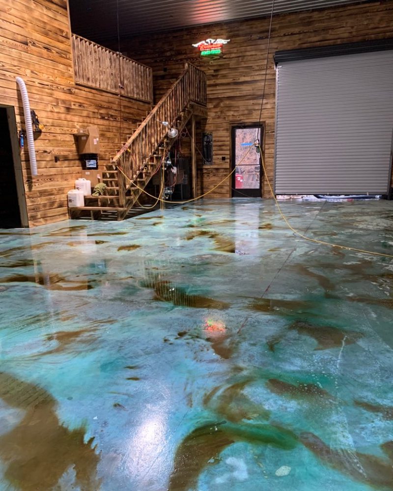 Sealed garage floor with vibrant Azure Blue and Shifting Sand hues
