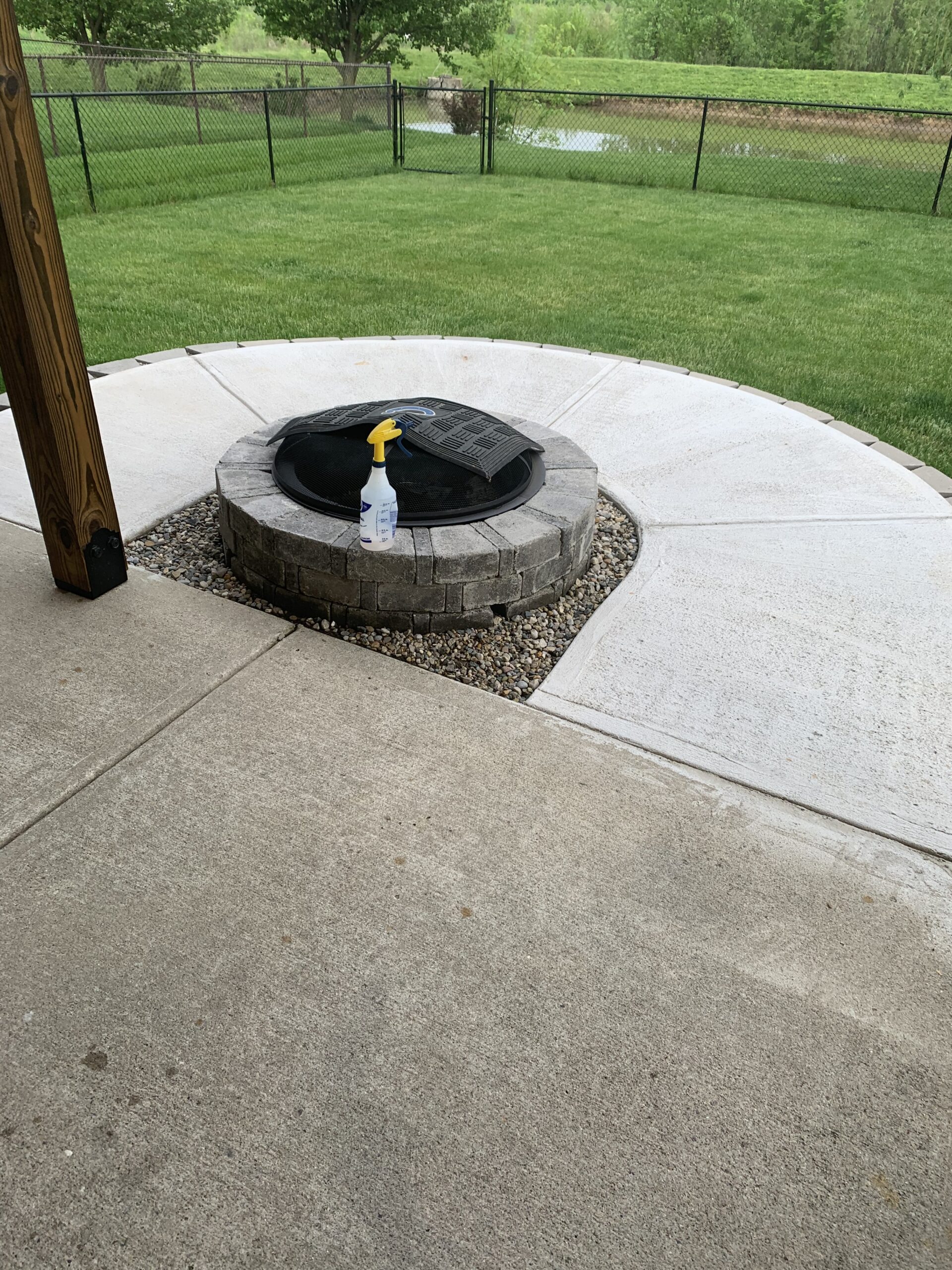 A round patio showcasing the contrast between the newer, fresh concrete and the adjacent aged, weathered concrete