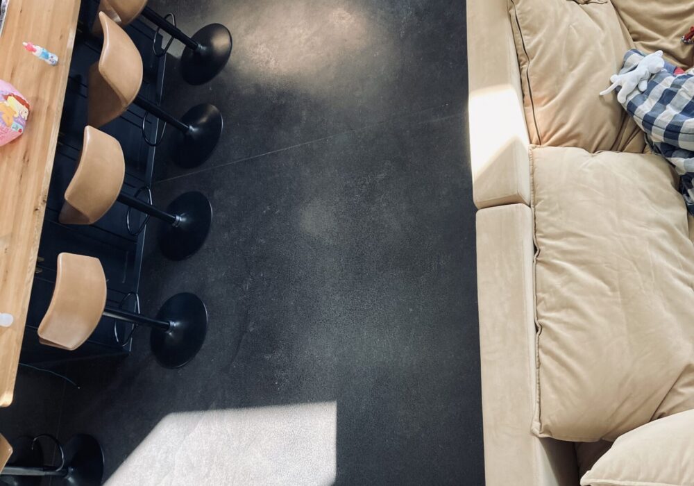 Overhead view from a staircase showcasing a gleaming finished floor stained in rich black AcquaTint
