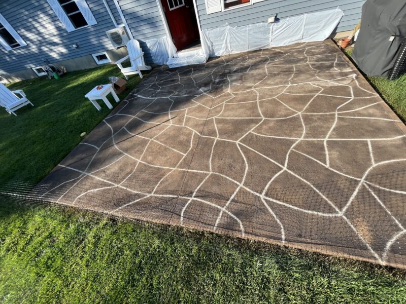 Patio surface post black EverStain acid stain neutralization, wash, and sealing