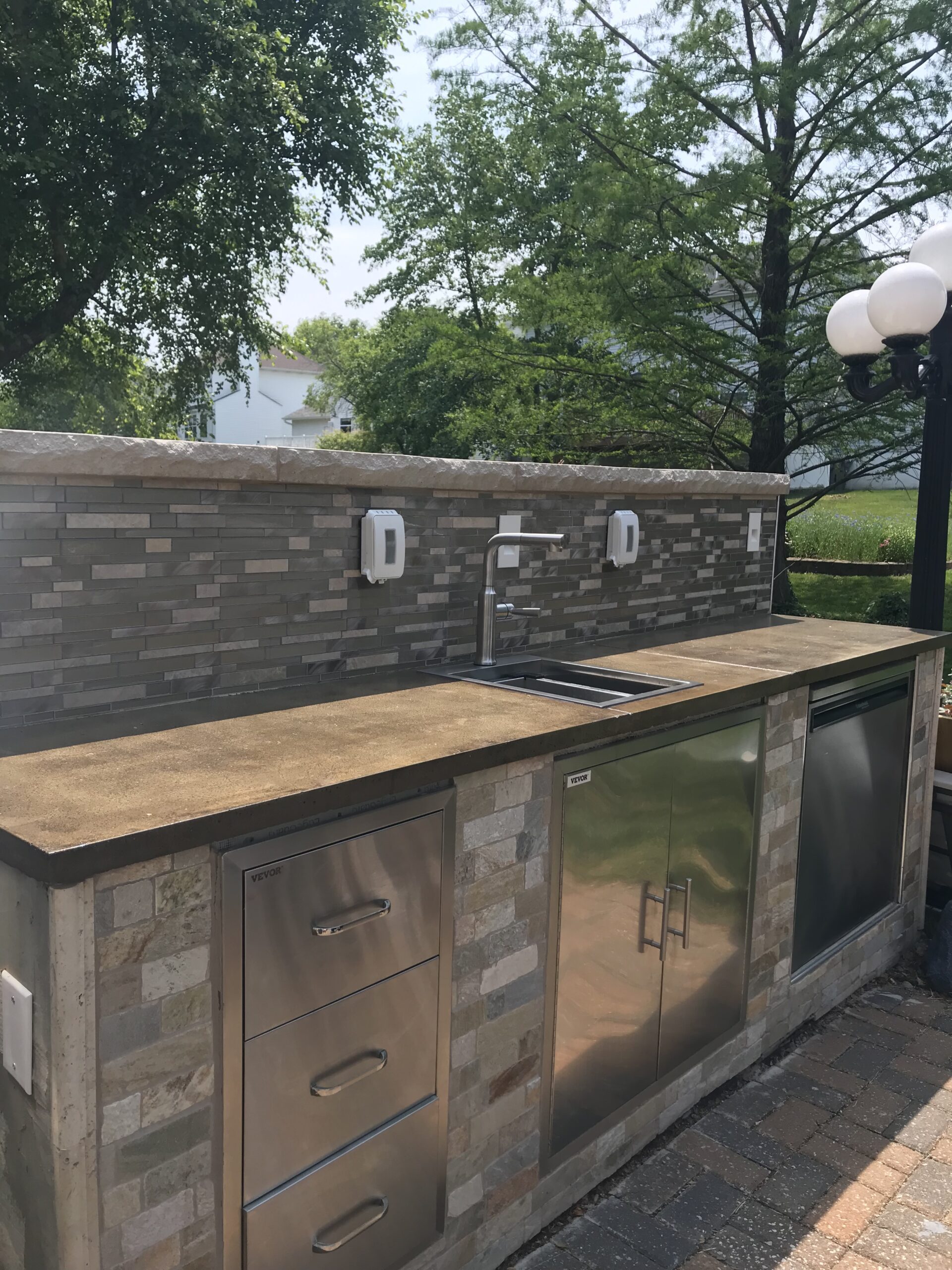Outdoor kitchen countertop stained with Molasses ColorWave, showcasing a rich and warm surface perfect for outdoor entertaining