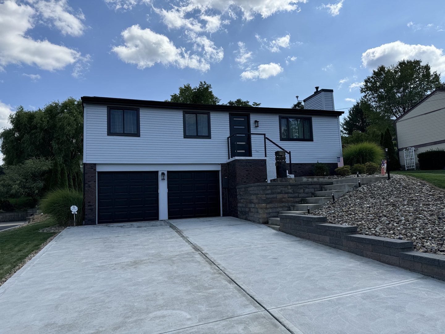 After photo of a brick wall on home facade stained with charcoal
